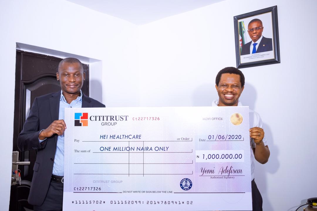 Group Chief Executive, Cititrust Group, Mr Yemi Adefisan (left) and the Founder, Health Emergency Initiative, Mr Paschal Achunine, during the cheque presentation ceremony in Lagos, today.